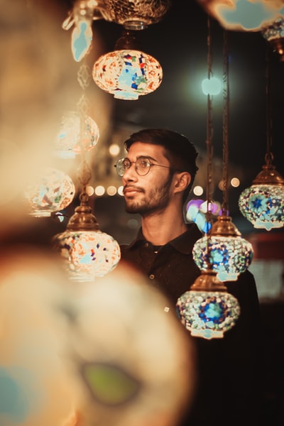 Dressed in a black round collar shirt, the man with glasses
